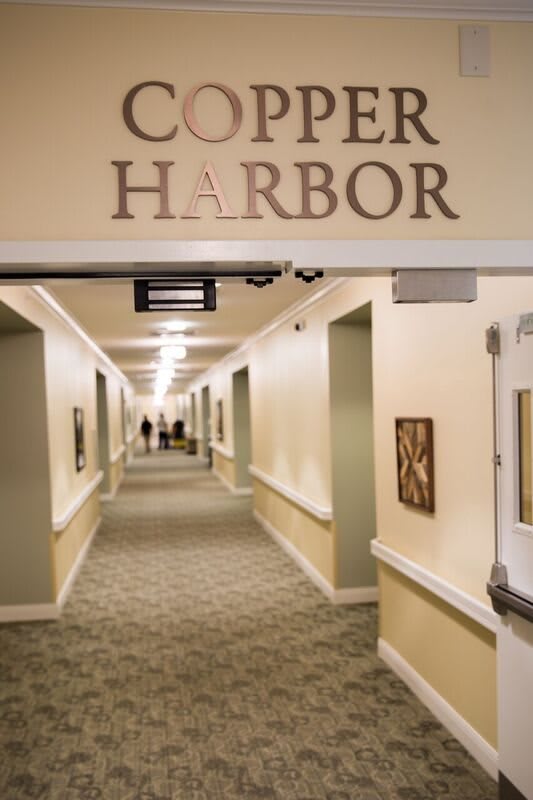 A well-lit hallway with the sign 'Copper Harbor' overhead.