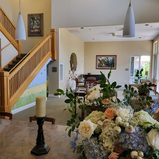 A beautifully decorated interior featuring a staircase and a floral arrangement.