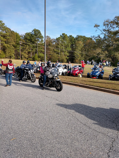 A gathering of motorcycle enthusiasts showcasing their bikes in a scenic outdoor setting.
