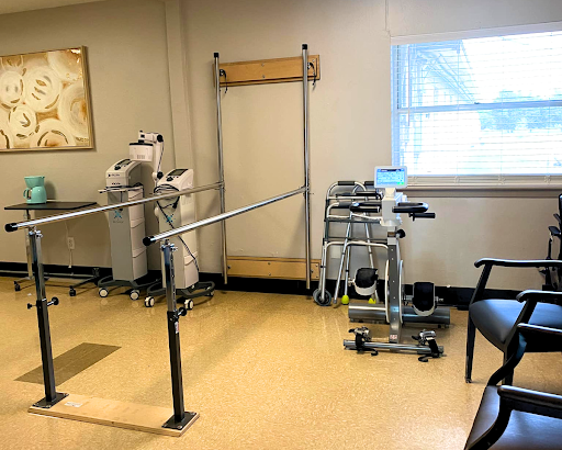A physical therapy room equipped with rehabilitation tools and exercise equipment.