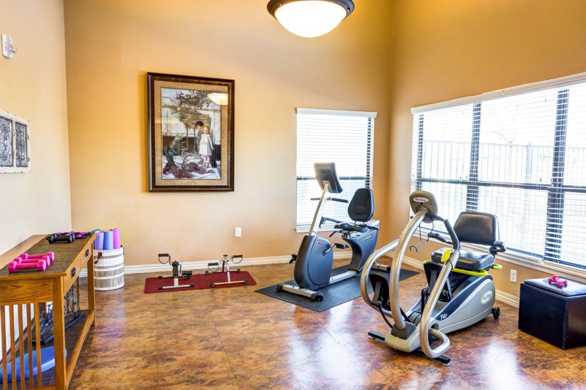 A small fitness room with exercise bikes and workout equipment.