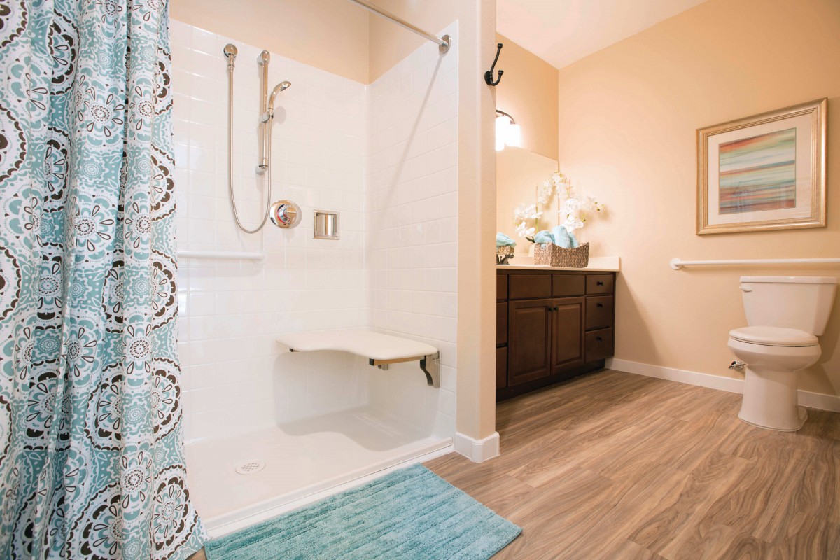 Modern bathroom with a walk-in shower and bench seating.
