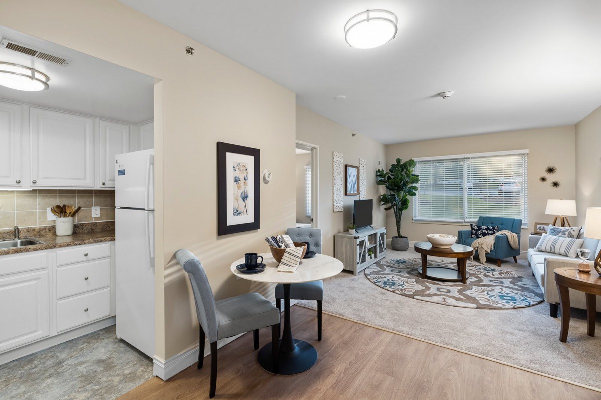 A cozy apartment with a connected living and dining area featuring modern decor and comfortable furnishings.