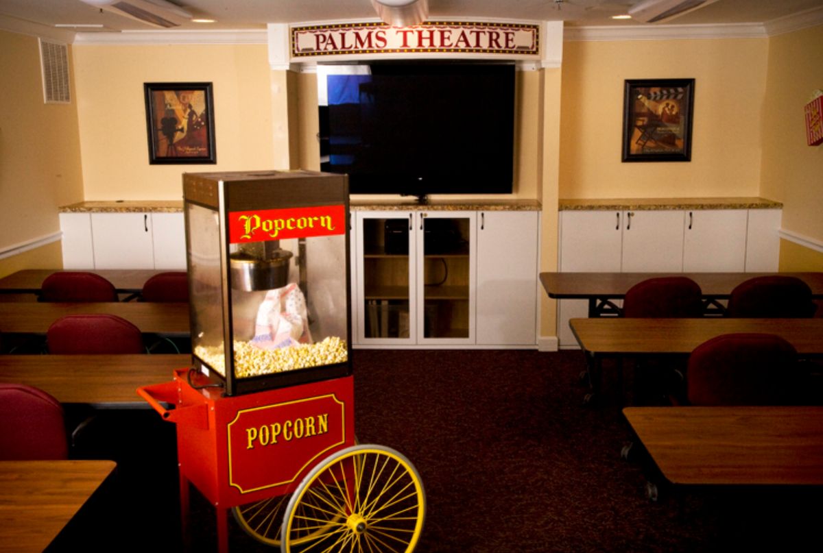 A cozy home theater setup featuring a popcorn machine and comfortable seating.