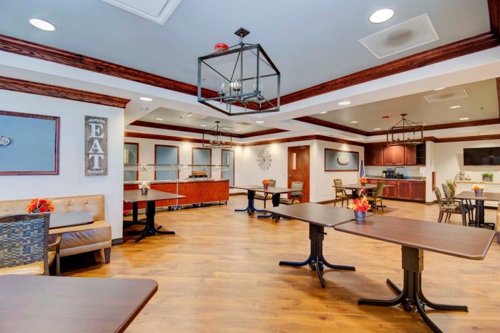 A well-lit dining area featuring tables and chairs with modern decor.