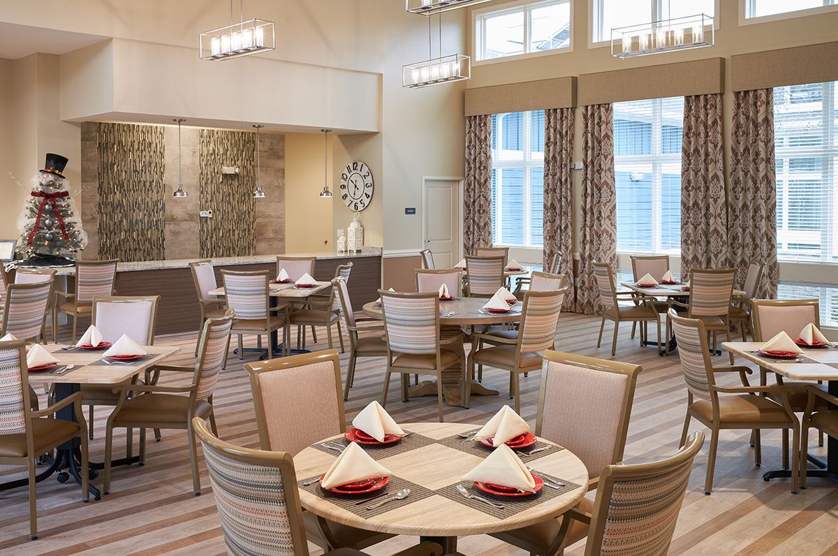 A neatly arranged restaurant dining area with elegantly set tables and modern decor.