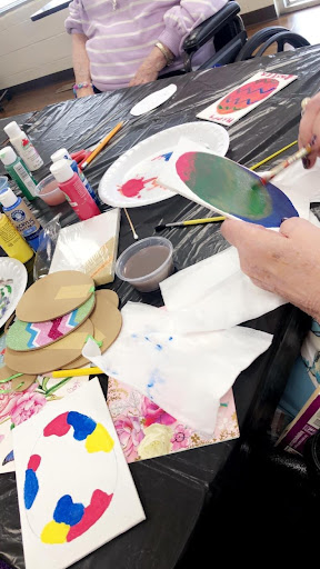 A vibrant art session in progress, filled with colorful paints and creative expressions.