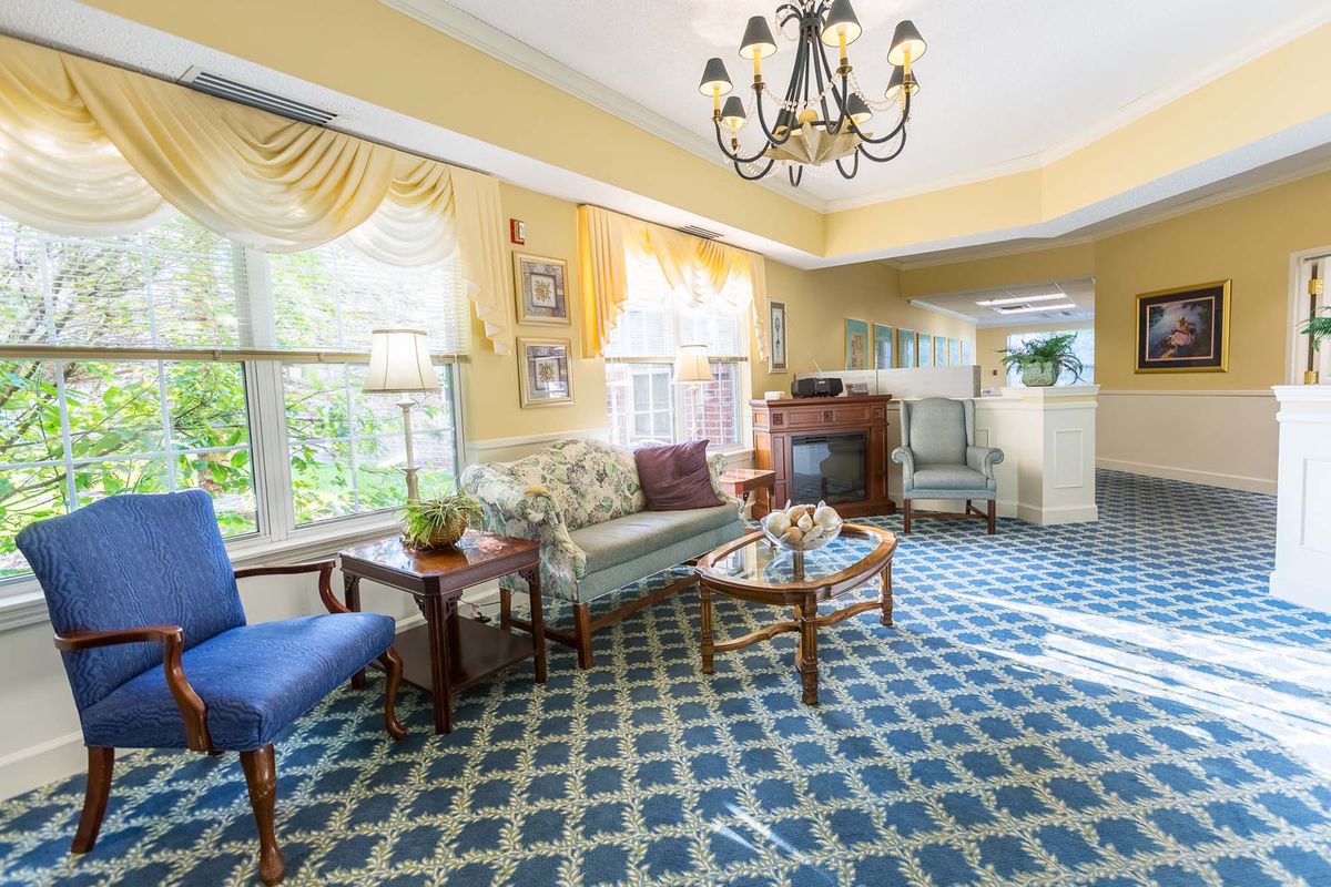 A traditional living room with elegant furnishings and a chandelier.