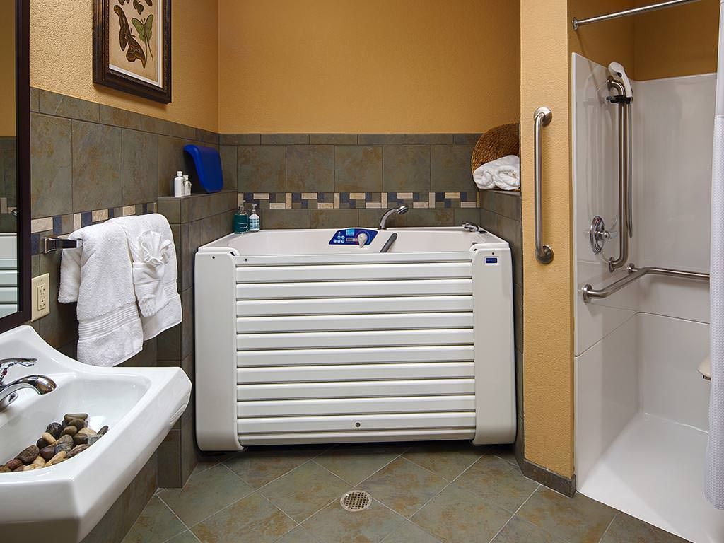 A well-appointed bathroom featuring a modern bathtub and walk-in shower, designed for accessibility.