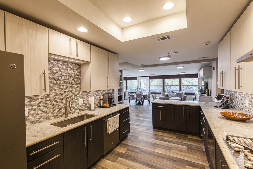 A modern kitchen with sleek cabinetry and an open layout.