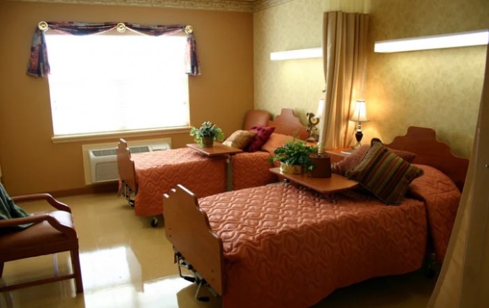 A cozy room with twin beds and warm lighting.
