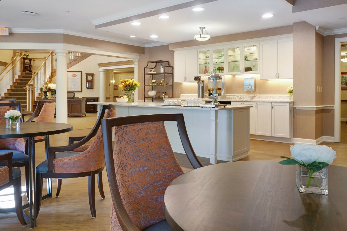 A modern kitchen and dining area with stylish furniture and bright lighting.