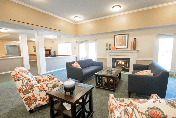 A cozy living room with modern furniture and a fireplace.
