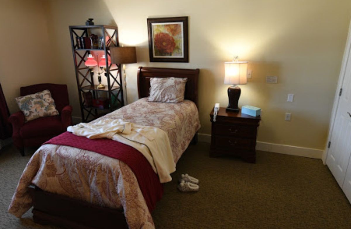 A cozy bedroom with a single bed, nightstand, and decorative elements.