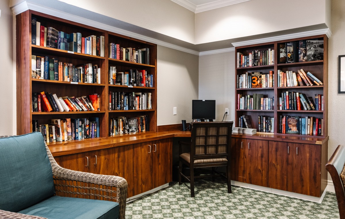 Cozy study room with bookshelves and a computer desk.