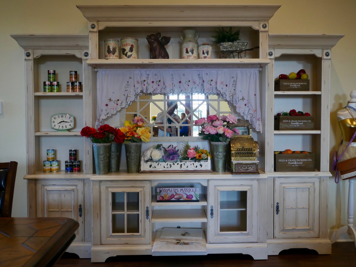 A vintage-style cabinet adorned with decorative flowers and ornaments.