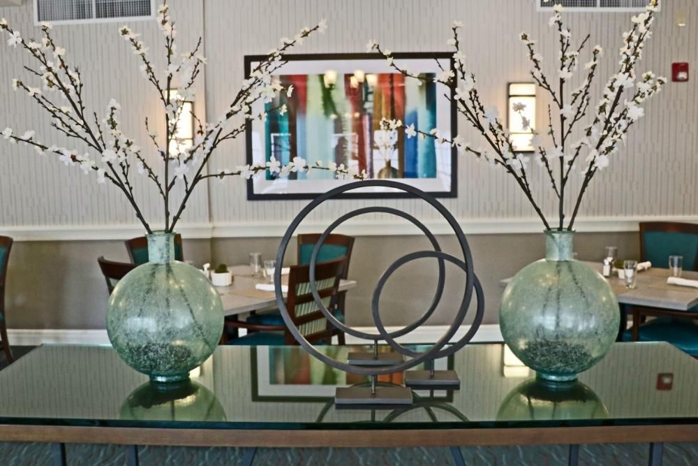 A modern interior design setup featuring decorative vases and abstract art.