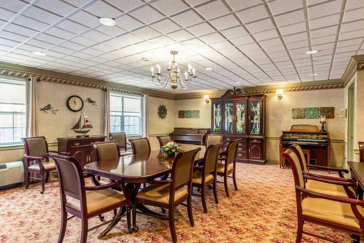 An elegant dining room with traditional furniture and a chandelier.