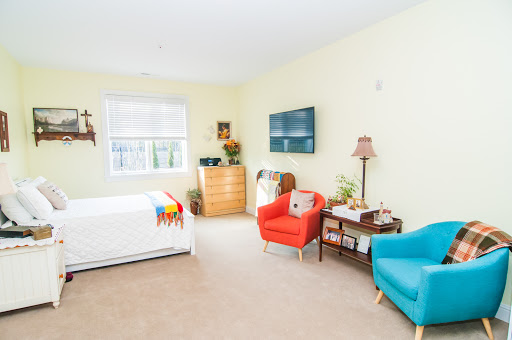 A bright and inviting bedroom featuring colorful furniture and a television.