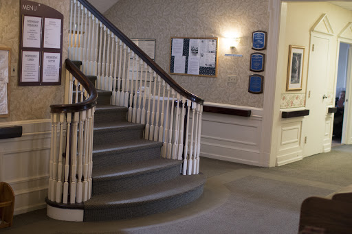 A view of the interior lobby featuring a spiral staircase and decorative railing.