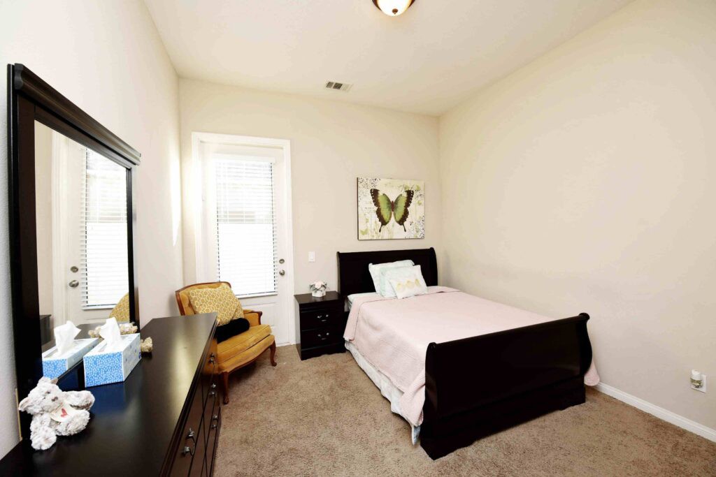 A cozy bedroom with a single bed and simple decor.