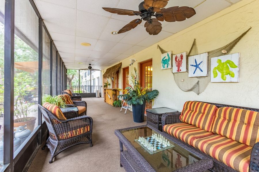 A cozy patio with wicker furniture and colorful decor providing a relaxing outdoor space.