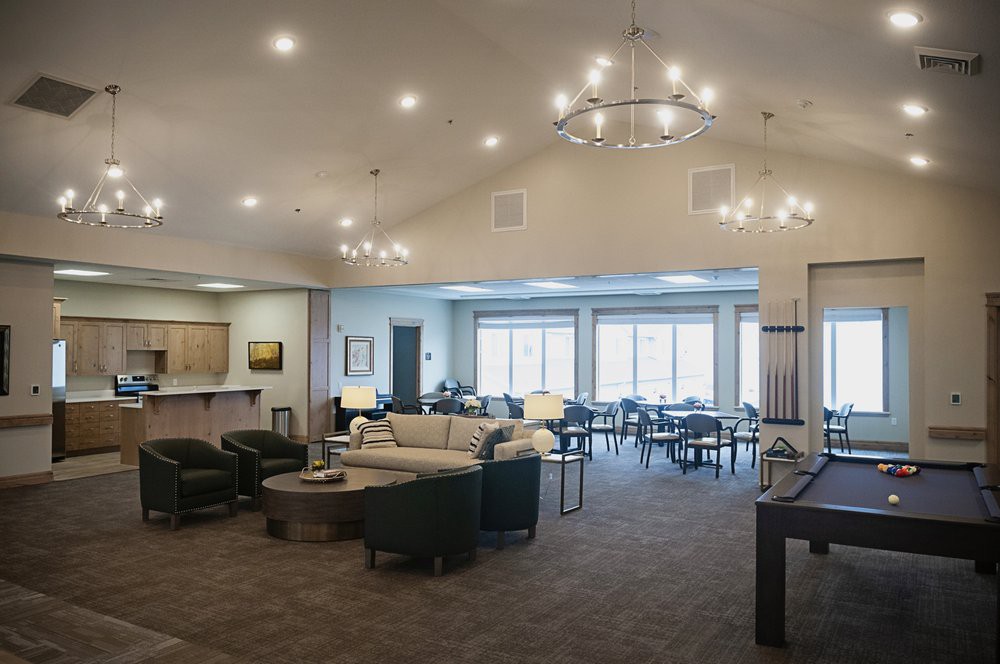 Spacious and elegantly furnished interior living area with comfortable seating and large windows.