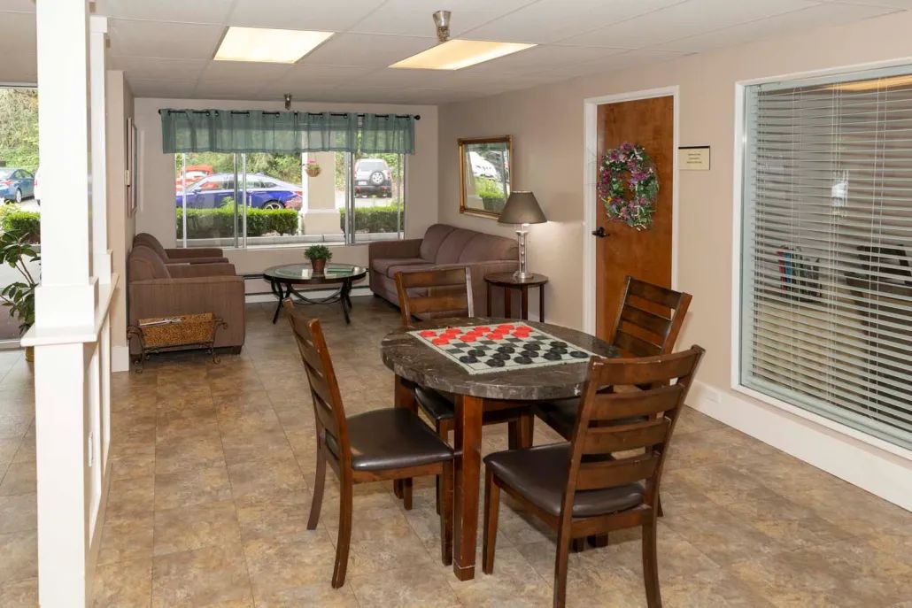 A cozy living room with a chess table and comfortable seating.