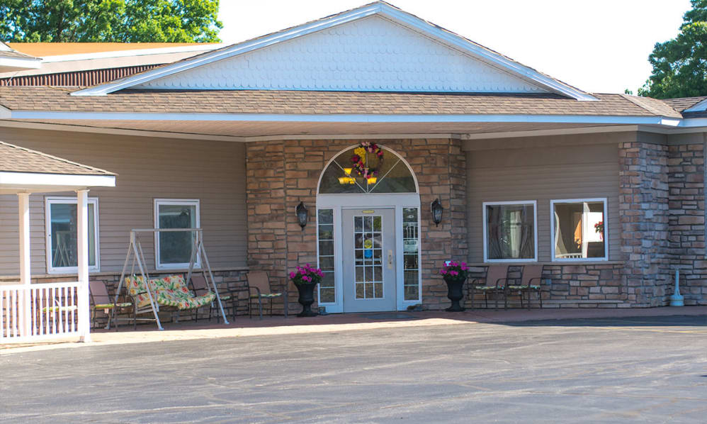 The image shows the entrance to a building with a symmetrical design, featuring double doors and flanked by windows.
