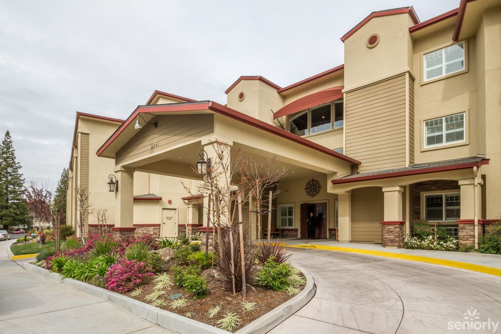 Modern hotel entrance with landscaped surroundings.