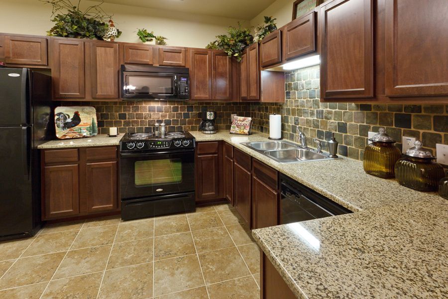 Stylish kitchen with granite countertops and wood cabinets.