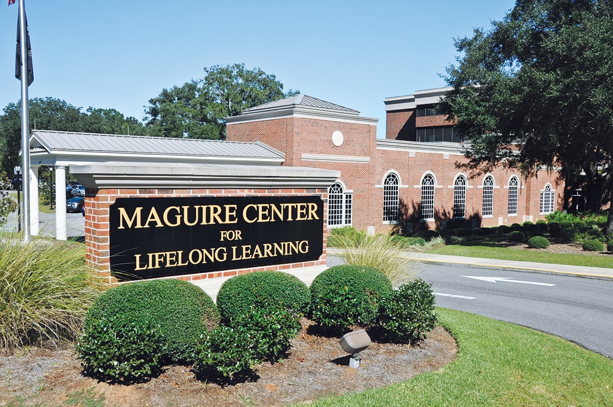 The Maguire Center for Lifelong Learning, showcasing its brick architecture and outdoor signage.