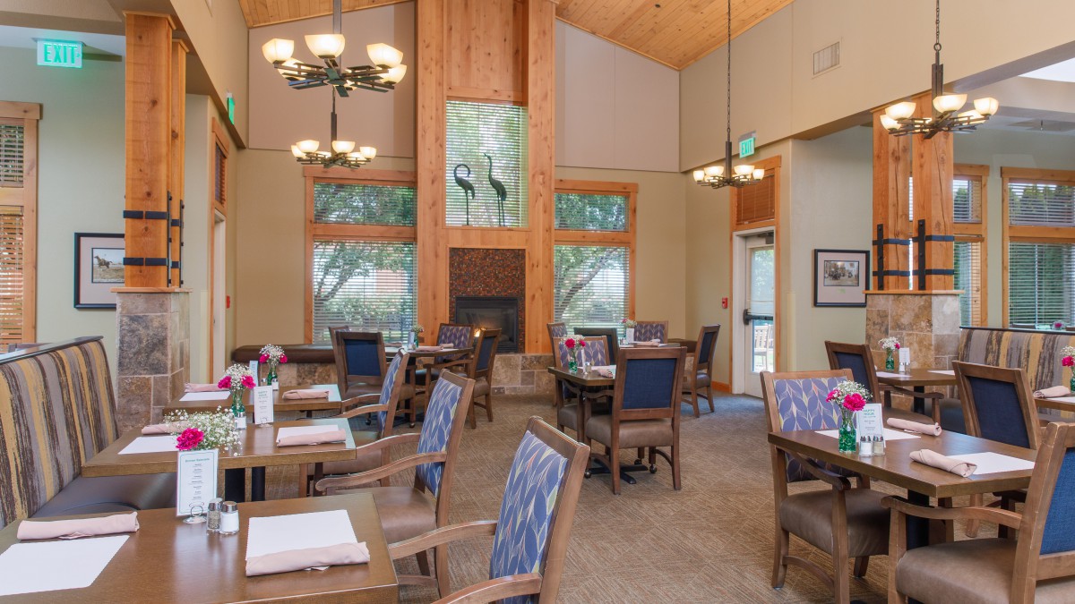 A cozy dining area with ample lighting and comfortable seating.