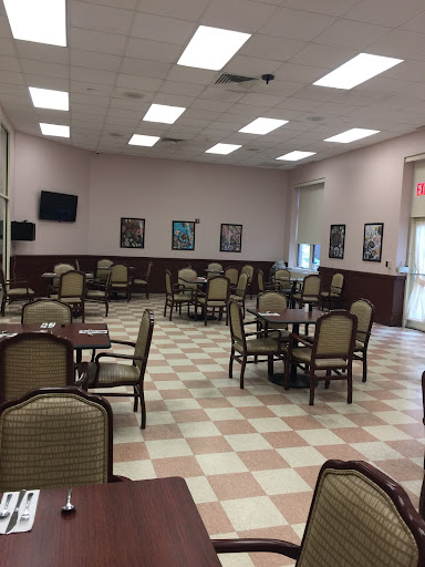 A spacious and well-lit dining area with tables and chairs, ready for guests.