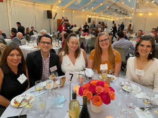 A group of friends enjoying a lively dinner event together.