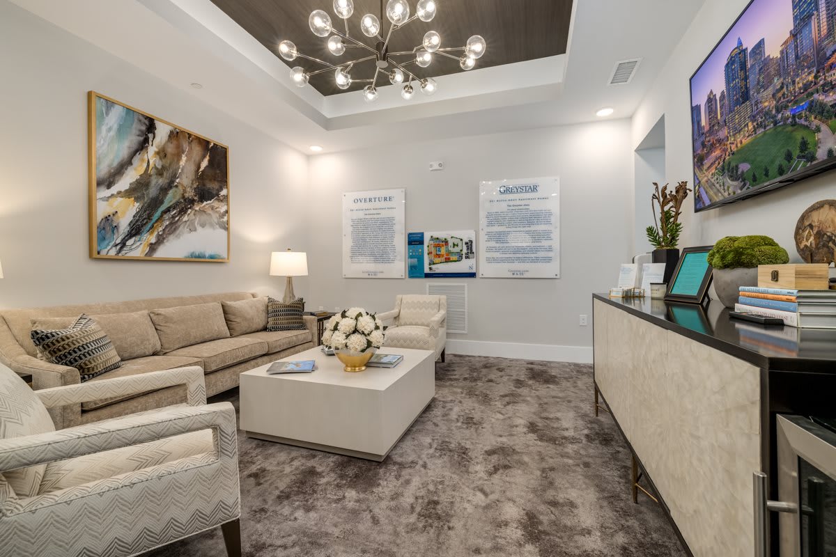 A modern waiting room with comfortable seating, stylish lighting, and decorative artwork.