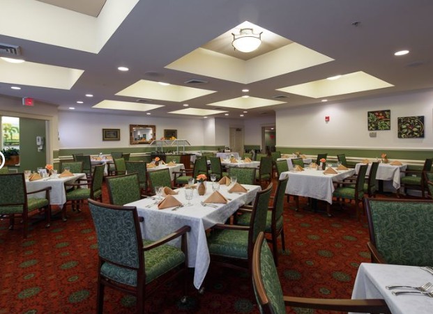 An elegantly decorated dining room with tables set for guests.
