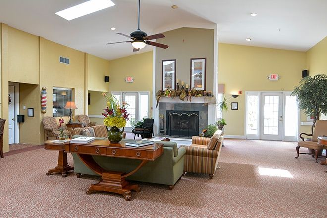 A spacious living room with a fireplace and cozy seating arrangement.