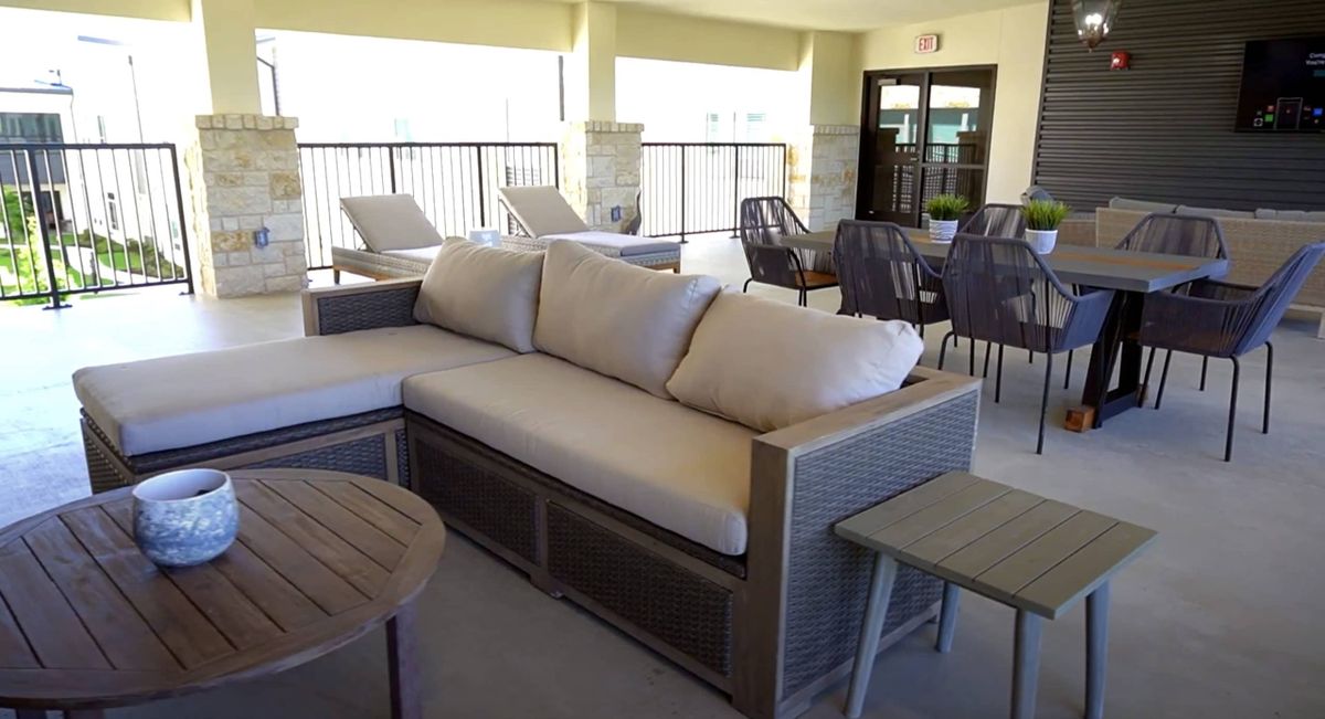 A modern outdoor patio with comfortable seating and a stylish sofa set.