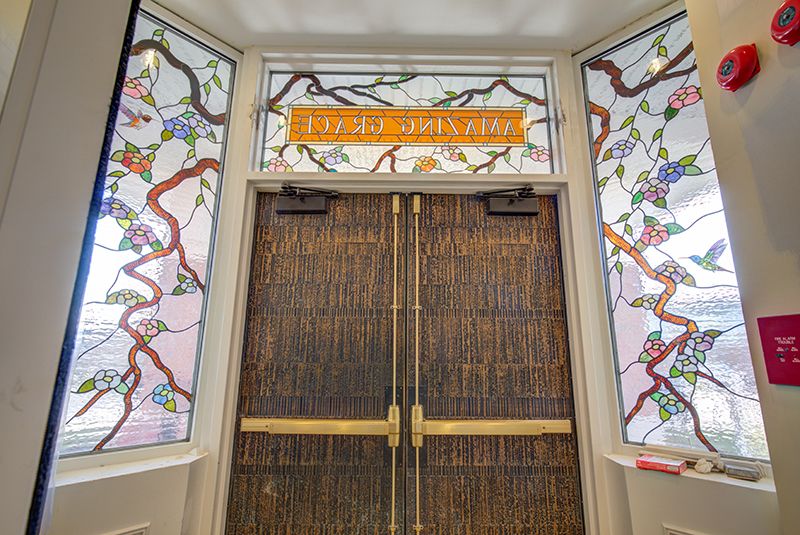 Intricately designed stained glass and wooden doors in an elegant setting.