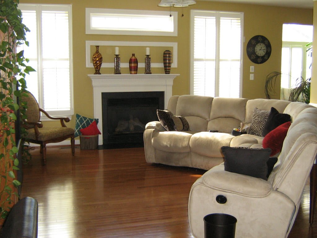 A cozy living room with a fireplace, comfortable sofas, and decorative elements.