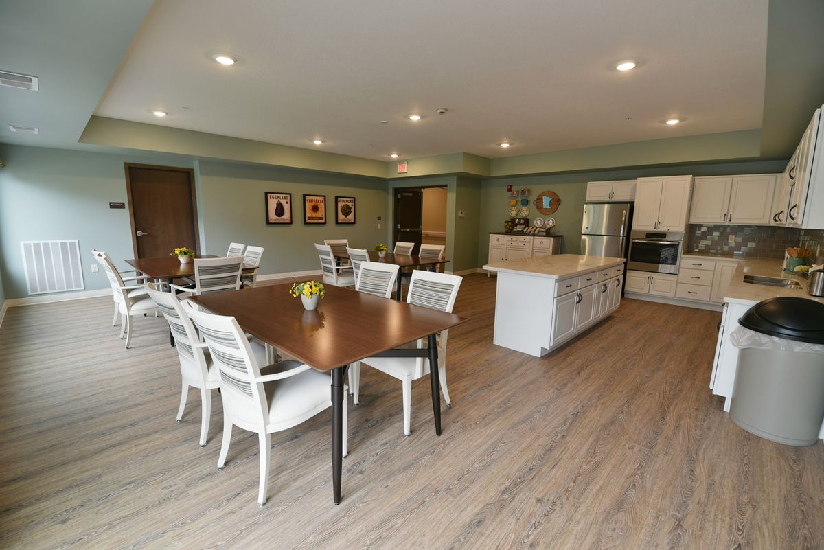 A spacious open-concept kitchen and dining area with modern furnishings and wood flooring.