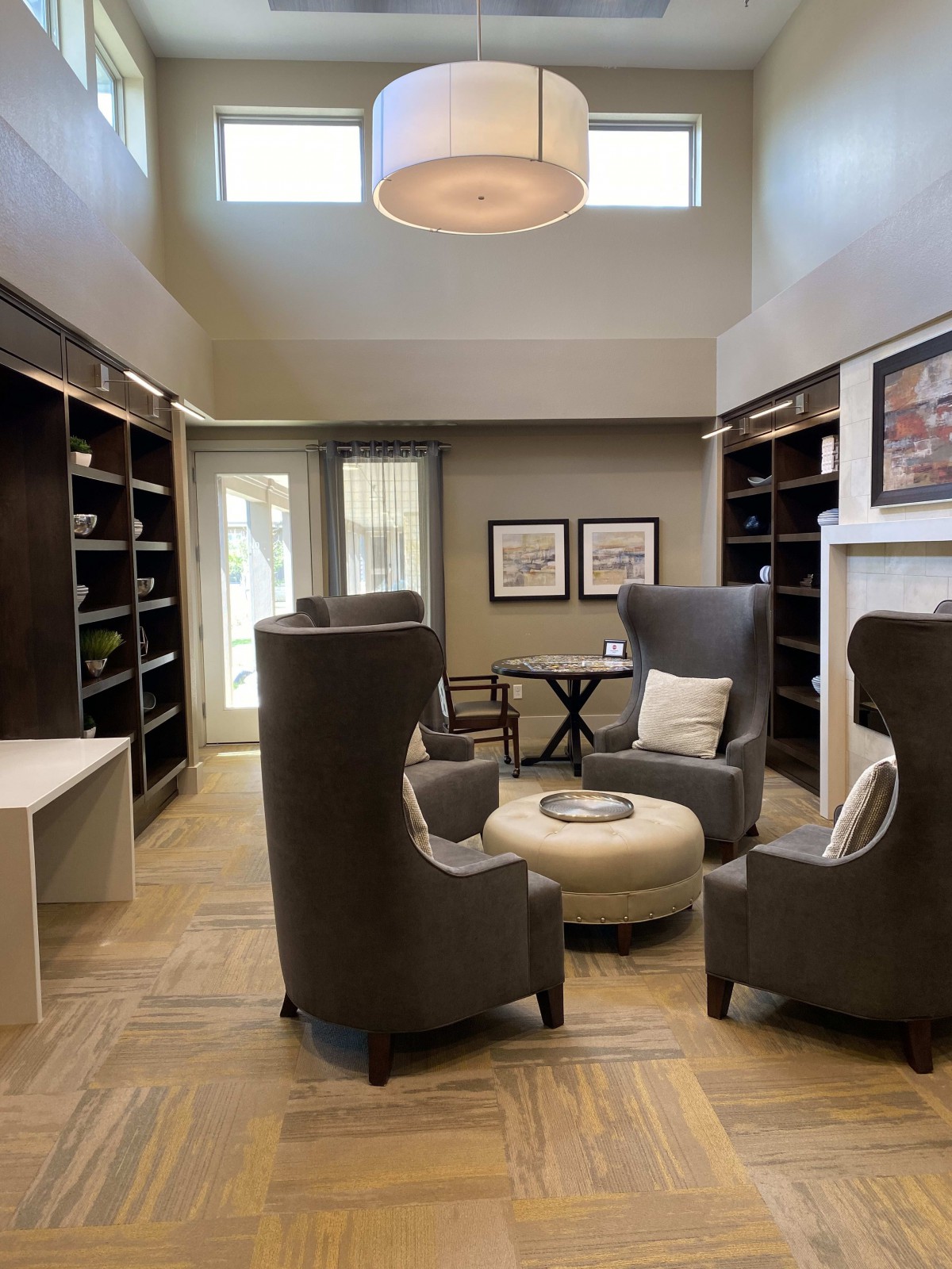 A cozy library space with modern armchairs and bookshelves.