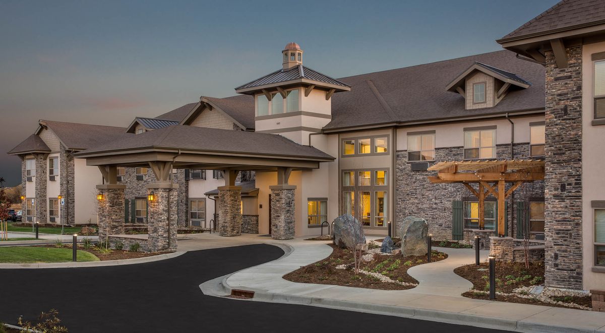 A luxurious residential building with stonework details at dusk.