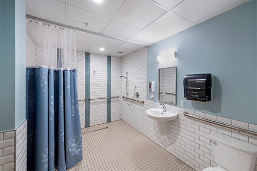 A clean, modern bathroom featuring a shower area and accessible amenities.