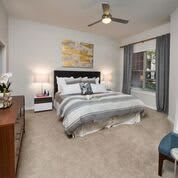 A modern bedroom with stylish decor and comfortable furnishings.