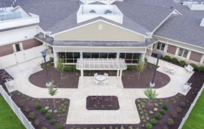 Aerial view of a building with a landscaped entrance.