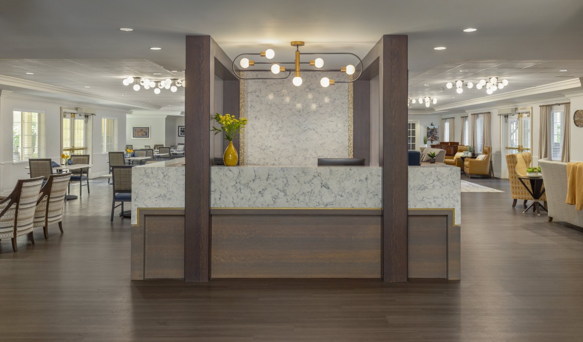 A modern reception area with stylish lighting and a marble accent wall.