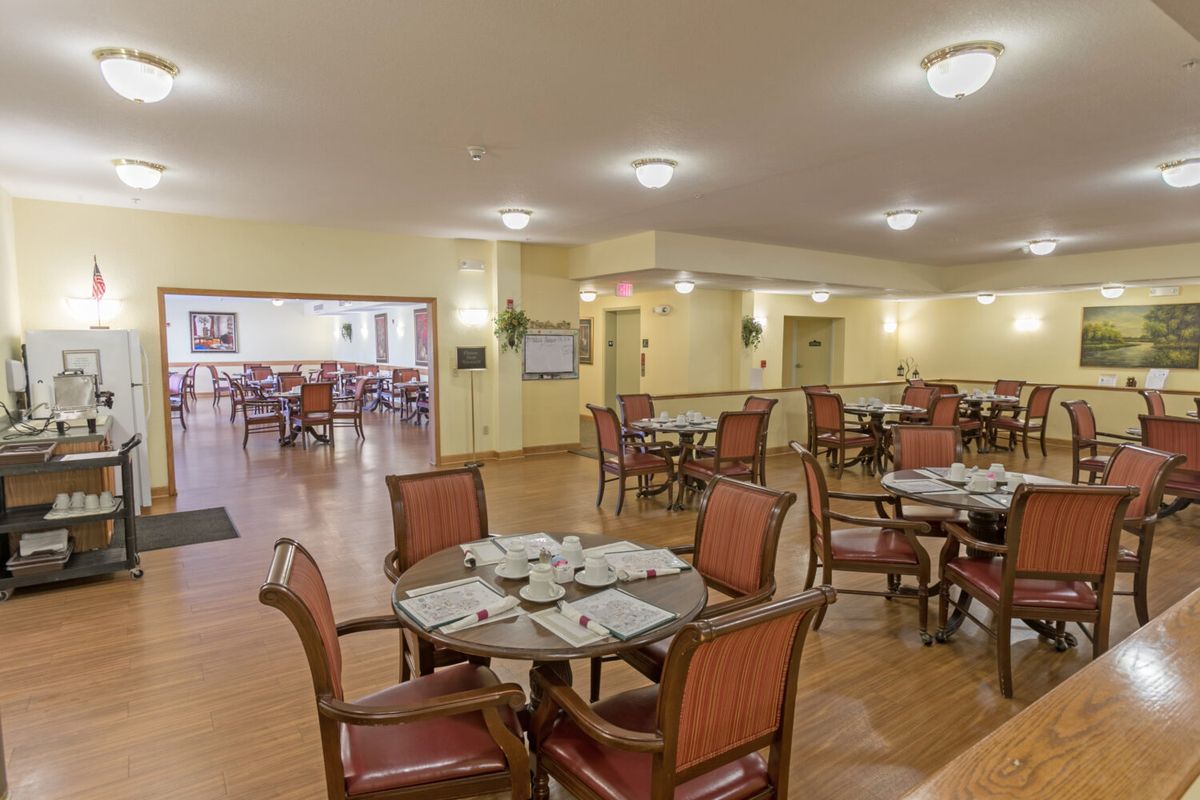 An empty dining area with multiple tables and chairs arranged neatly.