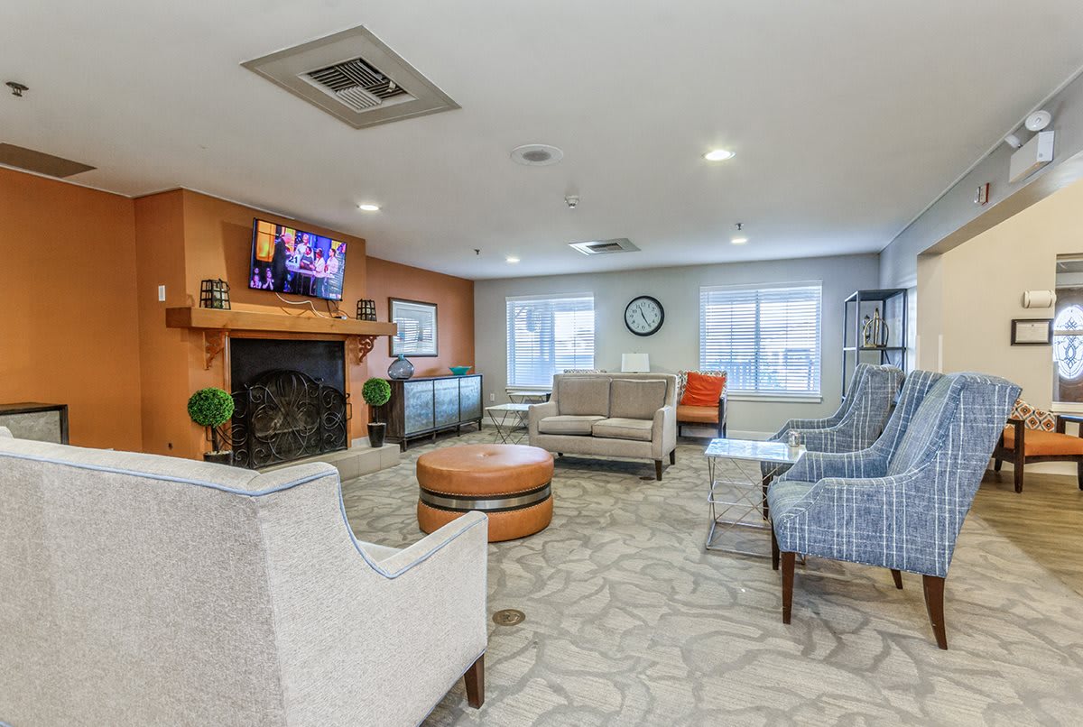 A modern living room with comfortable seating, a fireplace, and a television.